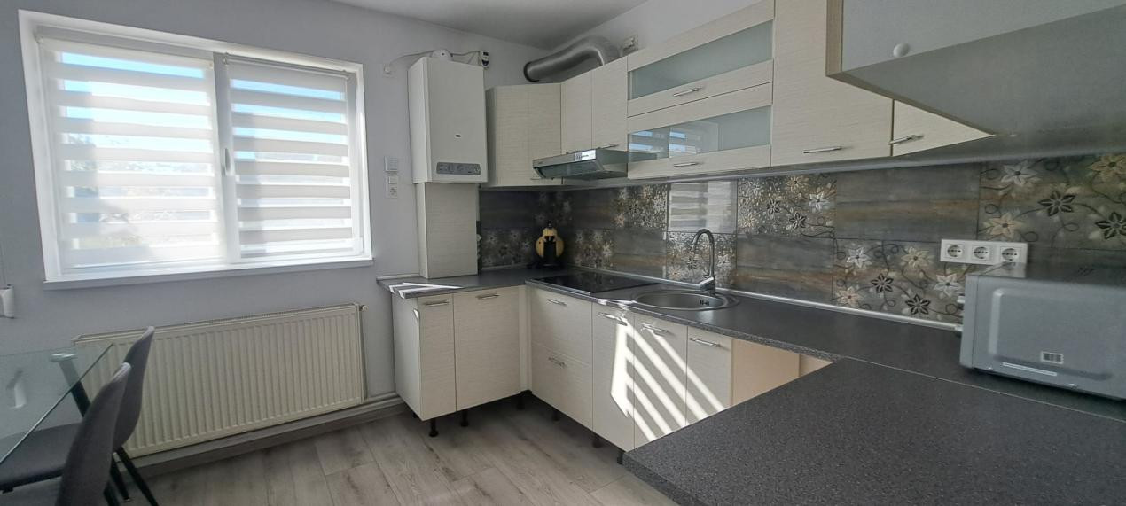 Apartament modern cu 2 camere, curte privată și 2 locuri de parcare